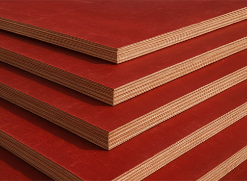 Edges of stacked film-faced shuttering plywood sheets
