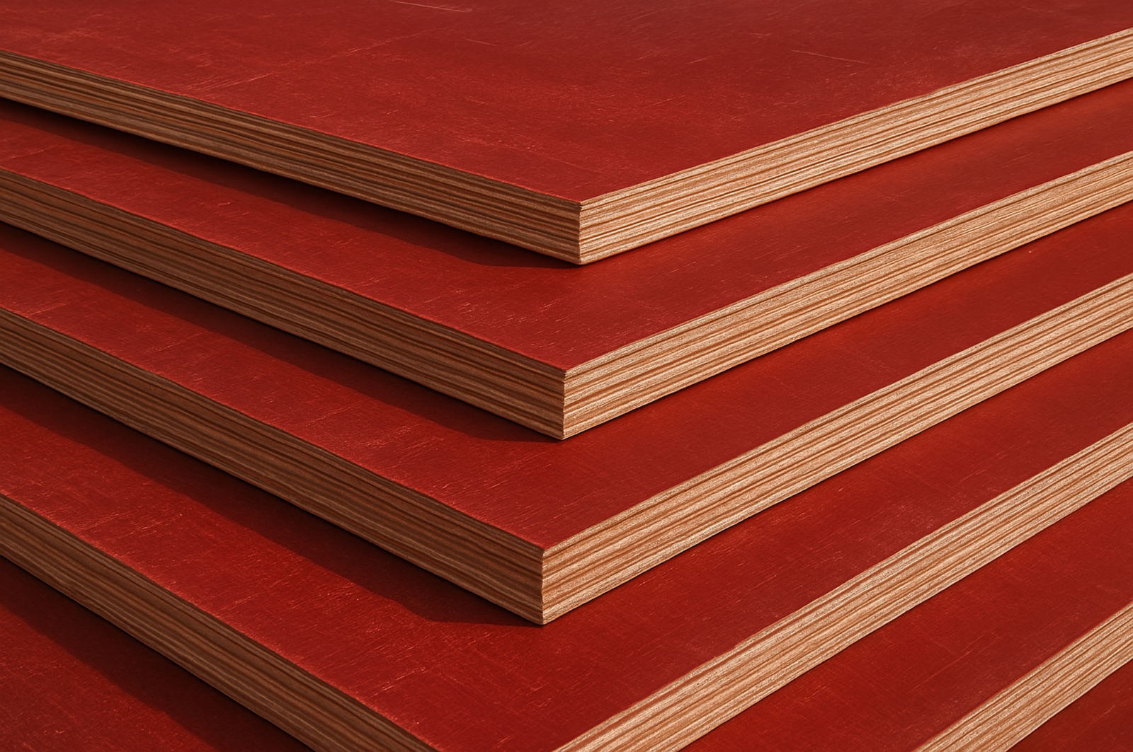 Edges of stacked film-faced shuttering plywood sheets