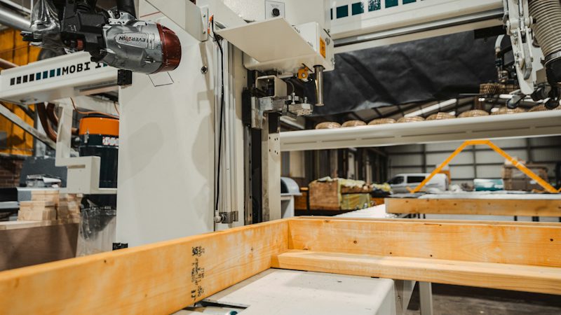 A timber beam on a machining line