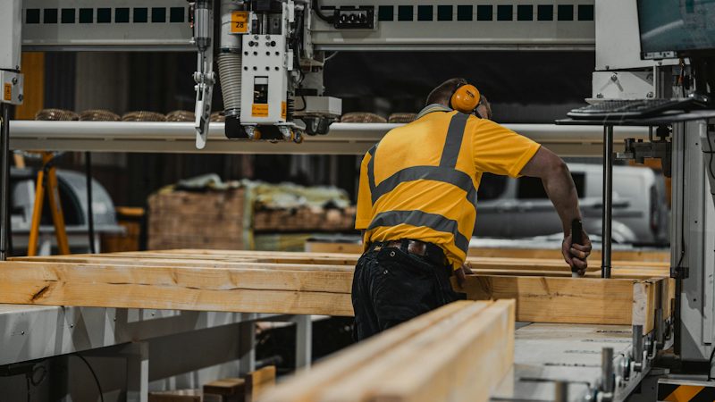 An operator feeding timber through a processing machine