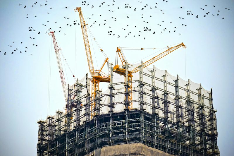 Tower cranes above a high-rise under construction