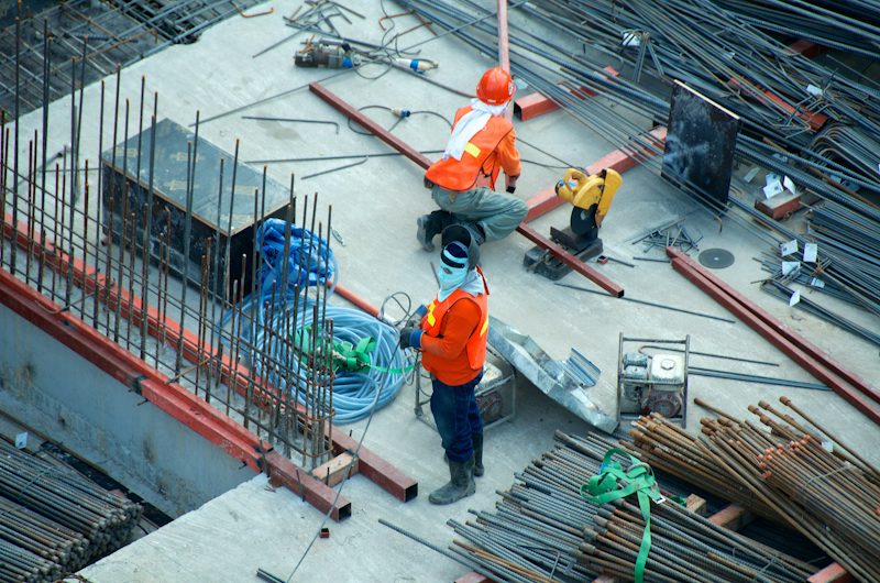 Workers fixing reinforcement on a concrete slab